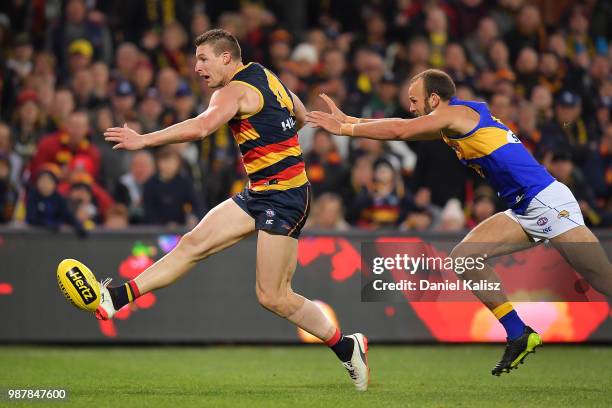 Josh Jenkins of the Crows kicks the ball during the round 15 AFL match between the Adelaide Crows and the West Coast Eagles at Adelaide Oval on June...