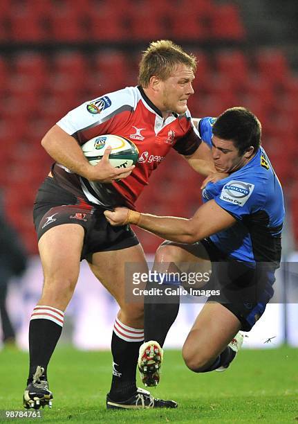 Ross Geldenhuys of the Lions tackled by Ben Whittaker of the Force during the Super 14 Round 12 match between Auto and General Lions and Western...