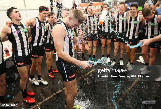 Brayden Sier of the Magpies gets a Gatorade shower after the Magpies won, during the round 15 AFL match between the Gold Coast Suns and the...