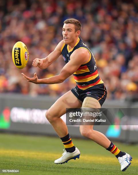 Paul Seedsman of the Crows handballs during the round 15 AFL match between the Adelaide Crows and the West Coast Eagles at Adelaide Oval on June 30,...