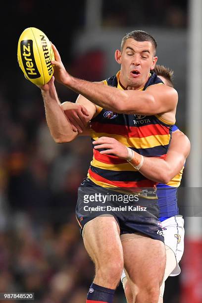 Taylor Walker of the Crows marks the ball during the round 15 AFL match between the Adelaide Crows and the West Coast Eagles at Adelaide Oval on June...