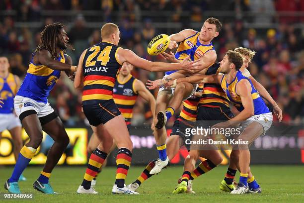 Players compete for the ball during the round 15 AFL match between the Adelaide Crows and the West Coast Eagles at Adelaide Oval on June 30, 2018 in...