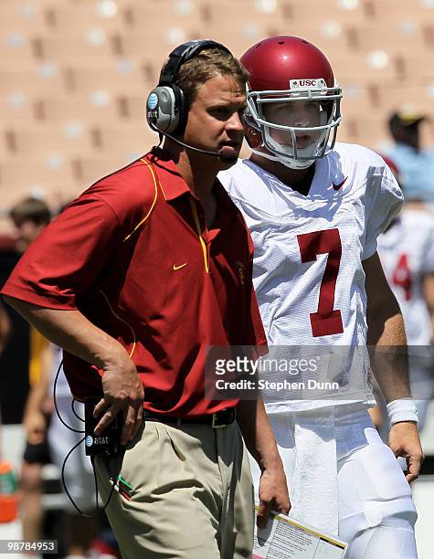 Head coach Lane Kiffin talks with quarterback Matt Barkley during the USC Trojans spring game on May 1, 2010 at the Los Angeles Memorial Coliseum in...