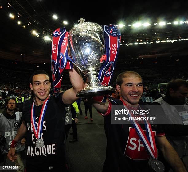 Paris Saint-Germain's French striker Mevlut Erding and Paris Saint-Germain's French defender Christophe Jallet celebrate with the trophy after...