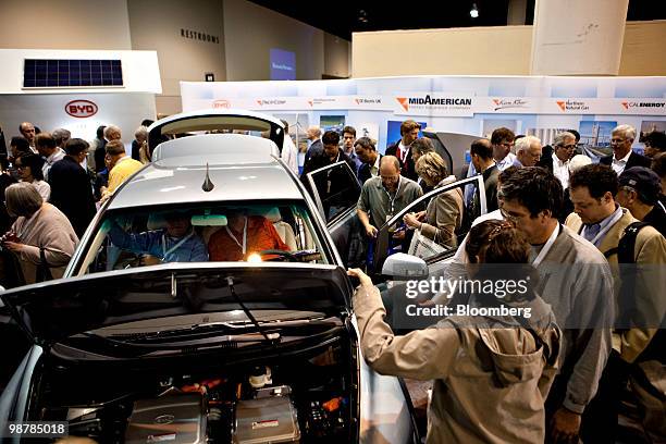 Shareholders look over a BYD Co. E6 electric vehicle on display during the Berkshire Hathaway Inc. Annual meeting in Omaha, Nebraska, U.S., on...