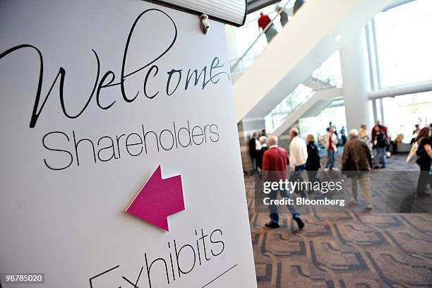 Sign points shareholders toward an exhibition area during the Berkshire Hathaway annual meeting in Omaha, Nebraska, U.S., on Saturday, May 1, 2010....