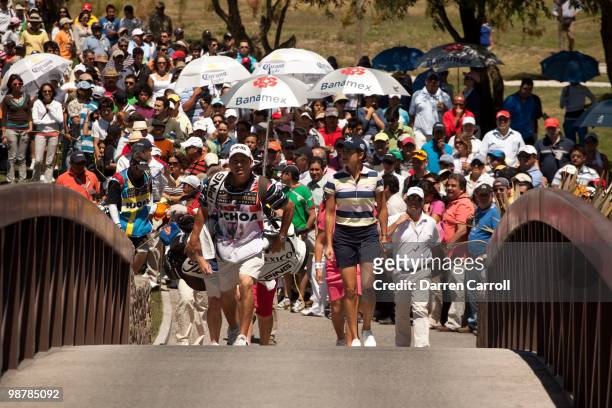 Lorena Ochoa of Mexico and caddie Greg Johnston walk across a bridge on the second hole during the third round of the Tres Marias Championship at the...