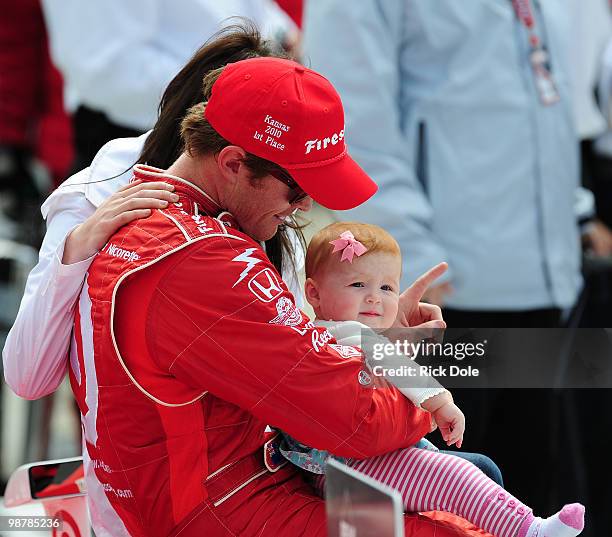 Winner Scott Dixon of New Zealand, driver of the Target Chip Ganassi Racing Dallara Honda, and holds his daughter Poppy during victory lane...