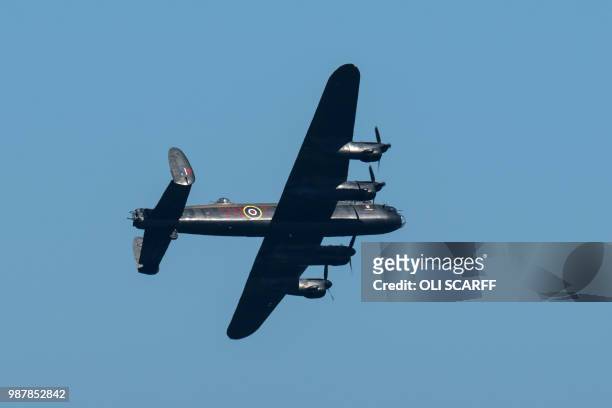 Lancaster bomber flies during an aerial display at the national Armed Forces Day celebrations at Llandudno, north Wales on June 30, 2018. - The...