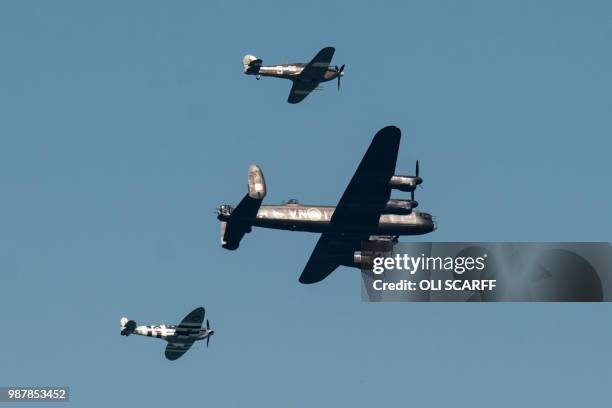 Spitfire , hurricane and a Lancaster bomber perform an aerobatic display during the national Armed Forces Day celebrations at Llandudno, north Wales...