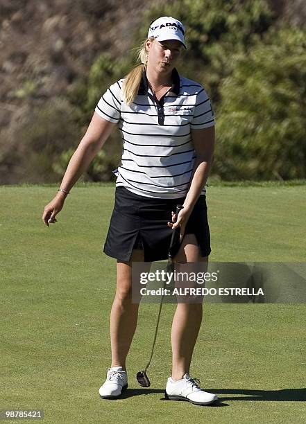 Golfer Brittany Lincicome reacts after her shot at the 18th hole during the third round of the Tres Marias Championship Open of the LPGA Tour at Tres...