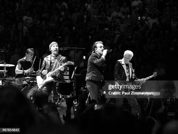 The Edge, Larry Mullen, Jr., Bono, and Adam Clayton of U2 perform onstage during the eXPERIENCE + iNNOCENCE TOUR at Prudential Center on June 29,...