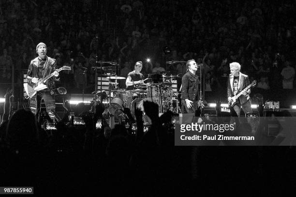 The Edge, Larry Mullen, Jr., Bono, and Adam Clayton of U2 perform onstage during the eXPERIENCE + iNNOCENCE TOUR at Prudential Center on June 29,...