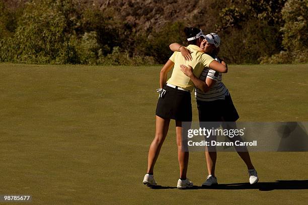 Ai Miyazato of Japan hugs playing partner Michelle Wie following the third round of the Tres Marias Championship at the Tres Marias Country Club on...