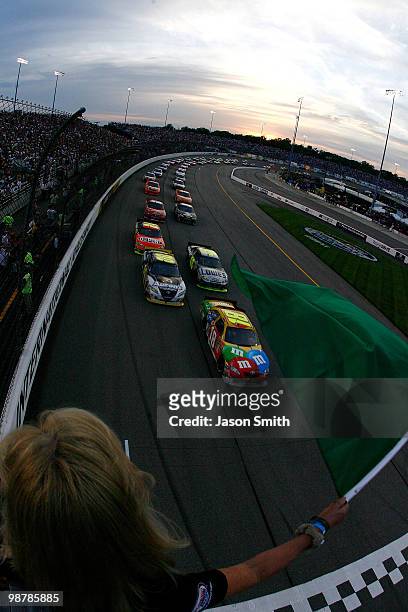 Kyle Busch, driver of the M&M's Toyota, leads the field at the start of the NASCAR Sprint Cup Series Crown Royal Presents the Heath Calhoun 400 at...