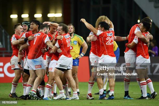Sunwolves players celebrate after defeating Bulls during the Super Rugby match at the Singapore National Stadium on June 30, 2018 in Singapore.
