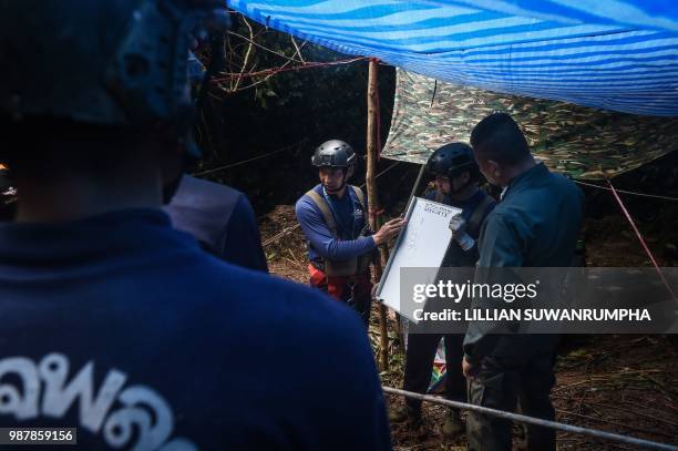 Thai Airforce specialist outlines plans to explore a possible opening to the Tham Luang cave, at the Khun Nam Nang Non Forest Park in Chiang Rai...