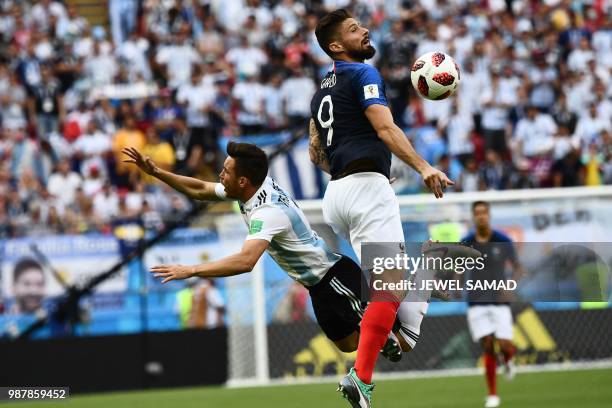 Argentina's defender Nicolas Tagliafico vies for the header with France's forward Olivier Giroud during the Russia 2018 World Cup round of 16...