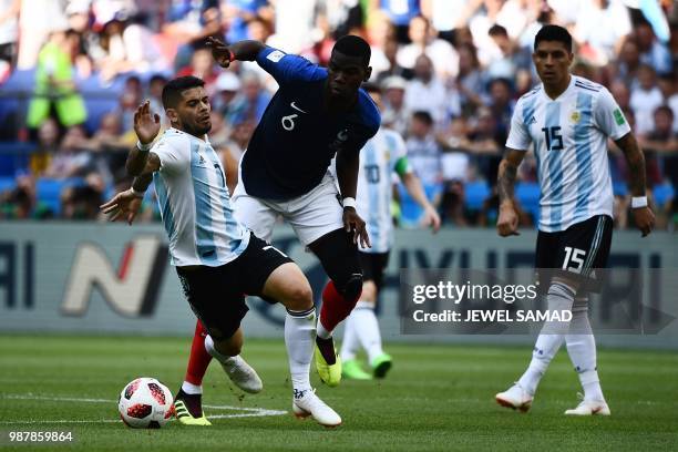 France's midfielder Paul Pogba vies for the ball with Argentina's midfielder Ever Banega during the Russia 2018 World Cup round of 16 football match...