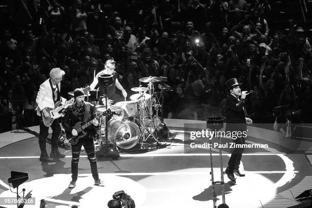 The Edge, Larry Mullen, Jr., Bono, and Adam Clayton of U2 perform onstage during the eXPERIENCE + iNNOCENCE TOUR at Prudential Center on June 29,...