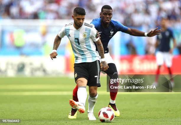 Ever Banega of Argentina and Paul Pogba of France battle for the ball during the 2018 FIFA World Cup Russia Round of 16 match between France and...