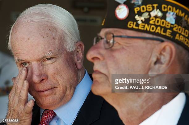 Senator John McCain wipes his eye just after the colors are presented as he attends ceremonies at the Veterans of Foreign Wars, the Sandy Coor Post,...