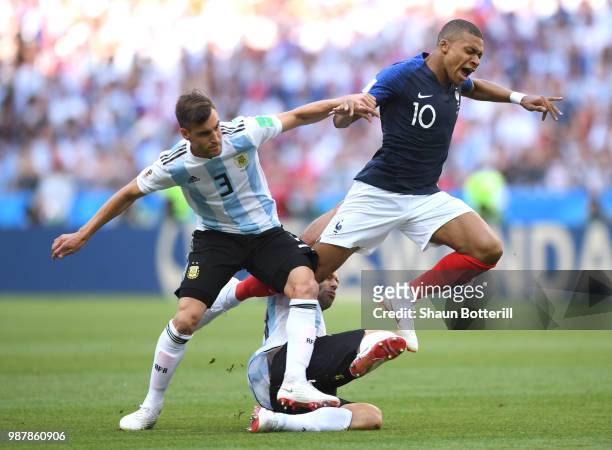 Kylian Mbappe of France is challenged by Ever Banega and Nicolas Tagliafico of Argentina during the 2018 FIFA World Cup Russia Round of 16 match...