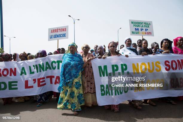 Malian women carry banners as they take part in a march on June 30, 2018 in Bamako organised by the Mouvement Peul, an organisation of ethnic Fulani...