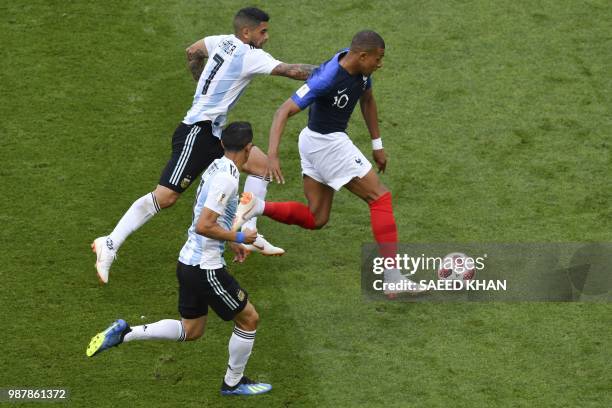 France's forward Kylian Mbappe vies for the ball with Argentina's midfielder Ever Banega and Argentina's forward Angel Di Maria during the Russia...