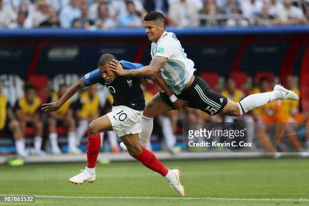 Marcos Rojo of Argentina fouls Kylian Mbappe of France to concede a penalty during the 2018 FIFA World Cup Russia Round of 16 match between France...