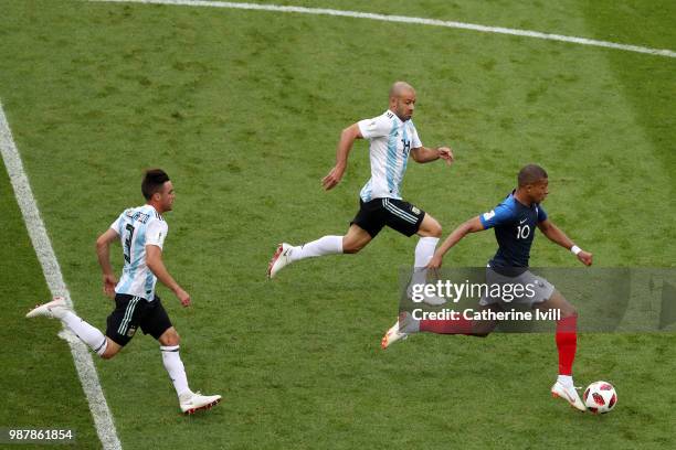 Kylian Mbappe of France is chased by Javier Mascherano anf Nicolas Tagliafico of Argentina during the 2018 FIFA World Cup Russia Round of 16 match...