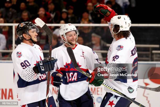 Nathan Walker of the USA celebrates with team mates after scoring a goal during the Ice Hockey Classic between the United States of America and...