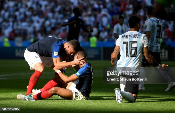 Olivier Giroud of France congratulates teammate Kylian Mbappe after gaining a penalty during the 2018 FIFA World Cup Russia Round of 16 match between...