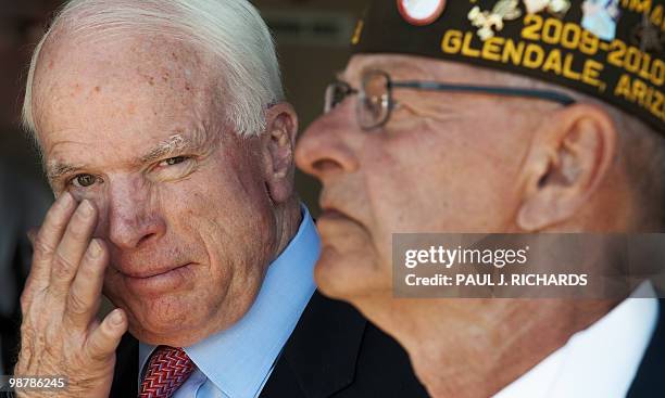 Senator John McCain wipes his eye just after the colors are presented as he attends ceremonies at the Veterans of Foreign Wars, the Sandy Coor Post,...