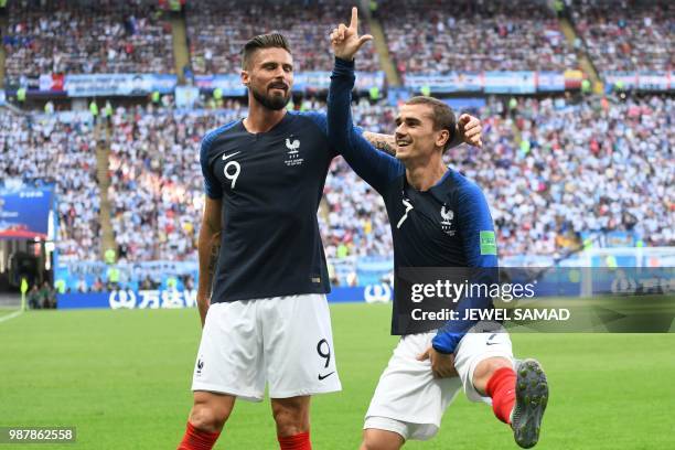 France's forward Antoine Griezmann celebrates after scoring with France's forward Olivier Giroud during the Russia 2018 World Cup round of 16...