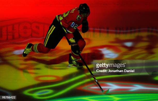Tomas Kopecky of the Chicago Blackhawks skates onto the ice during player introductions before the Blackhawks take on the Vancouver Canucks in Game...