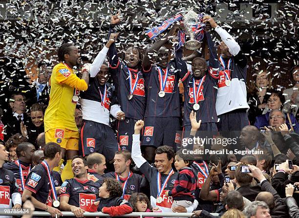 French midfielder and captain Claude Makelele celebrates with the Paris Saint Germain football club teammates after winning the French football Cup...