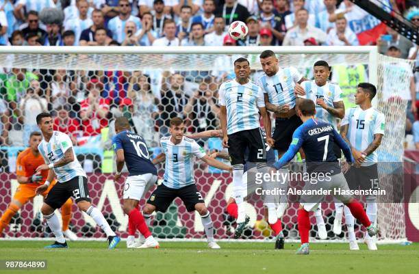Antoine Griezmann of France fires a free kick over Argentina's wall during the 2018 FIFA World Cup Russia Round of 16 match between France and...