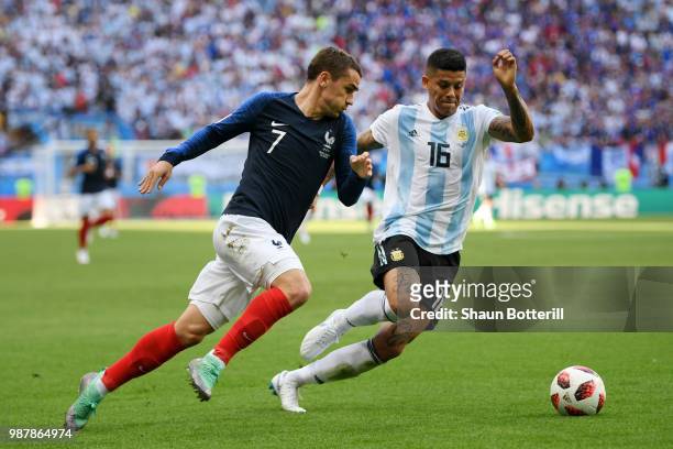 Antoine Griezmann of France is challenged by Marcos Rojo of Argentina during the 2018 FIFA World Cup Russia Round of 16 match between France and...