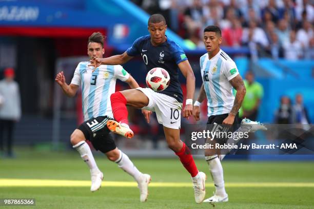 Kylian Mbappe of France competes with Marcos Rojo of Argentina during the 2018 FIFA World Cup Russia Round of 16 match between France and Argentina...