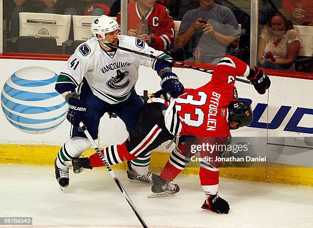 Andrew Alberts of the Vancouver Canucks knocks down Dustin Byfuglien of the Chicago Blackhawks in Game One of the Western Conference Semifinals...