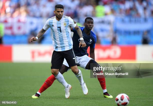 Paul Pogba of France challenge for the ball with Ever Banega of Argentina during the 2018 FIFA World Cup Russia Round of 16 match between France and...