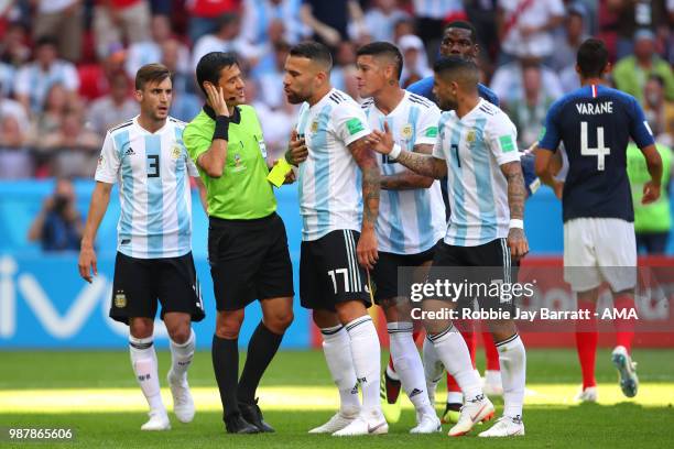 Nicolas Otamendi and Marcos Rojo of Argentina protest to Referee Alireza Faghan after he awarded a penalty to France during the 2018 FIFA World Cup...