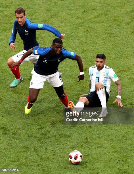Ever Banega of Argentina tackles Paul Pogba of France during the 2018 FIFA World Cup Russia Round of 16 match between France and Argentina at Kazan...