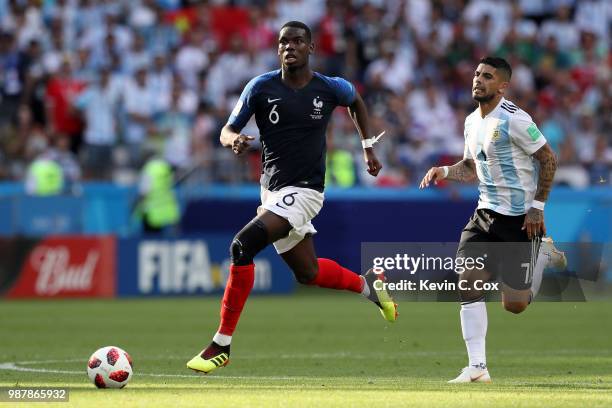 Ever Banega of Argentina chases down Paul Pogba of France during the 2018 FIFA World Cup Russia Round of 16 match between France and Argentina at...