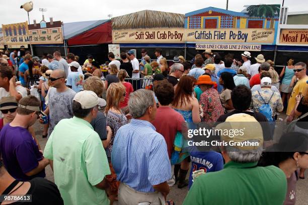 People line up for local seafood during the New Orleans Jazz & Heritage Festival at the Fair Grounds Race Course on May 1, 2010 in New Orleans,...