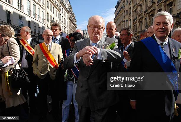 President of Front National, Jean Marie Le Pen inspects his watch as he and Bruno Gollnisch attend the French far right party's May Day Demonstration...