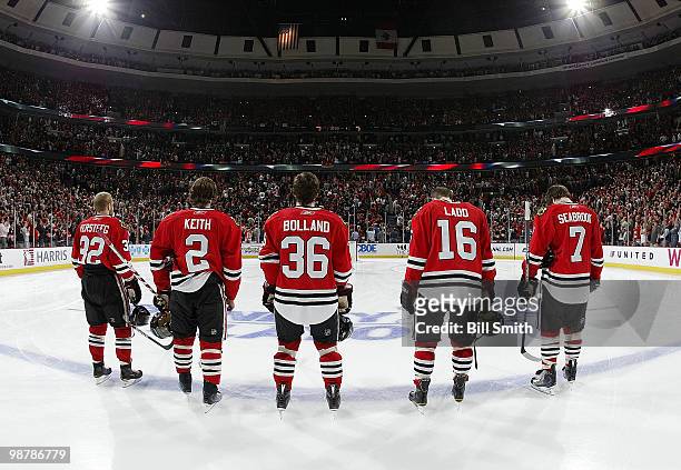 The Chicago Blackhawks starting lineup Kris Versteeg, Duncan Keith, Dave Bolland, Andrew Ladd, and Brent Seabrook stand for "The National Anthem"...