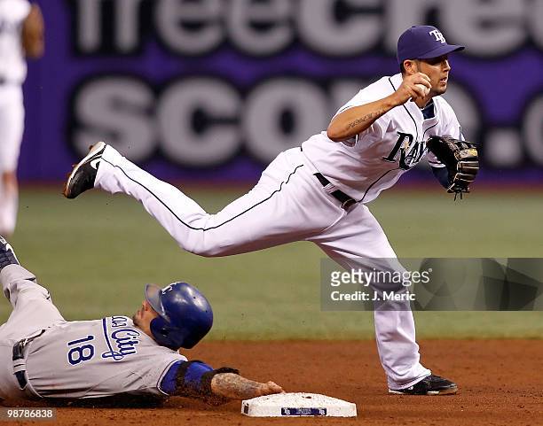 Shortstop Jason Bartlett of the Tampa Bay Rays attempts to turn a double play as Jason Kendall of the Kansas City Royals breaks it up during the game...