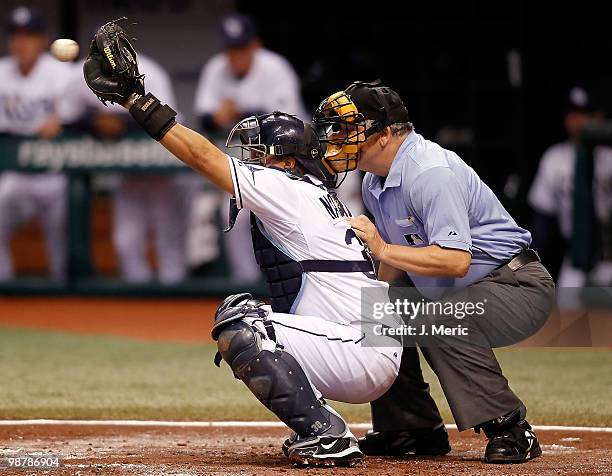 Catcher Dioner Navarro of the Tampa Bay Rays catches while homeplate umpire Jerry Crawford looks on against the Kansas City Royals during the game at...